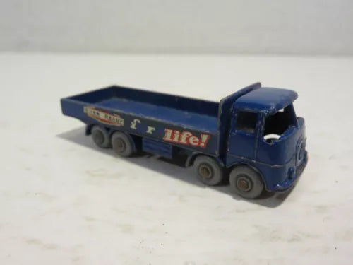 Blue diecast toy truck with attached flatbed trailer, vintage style