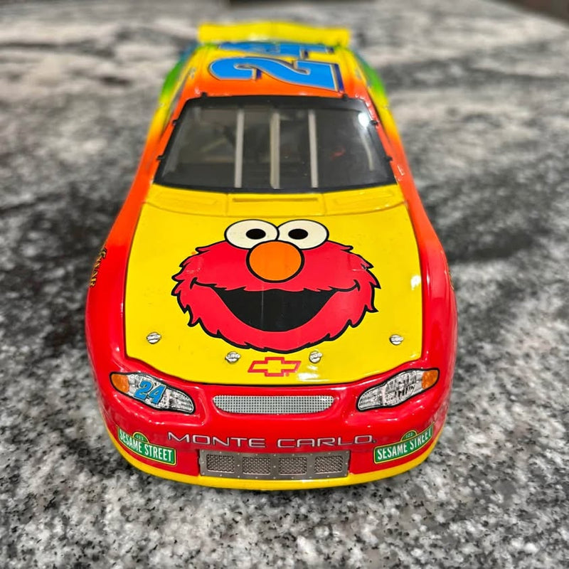 Elmo-themed NASCAR diecast race car, orange and yellow front with Sesame Street graphics