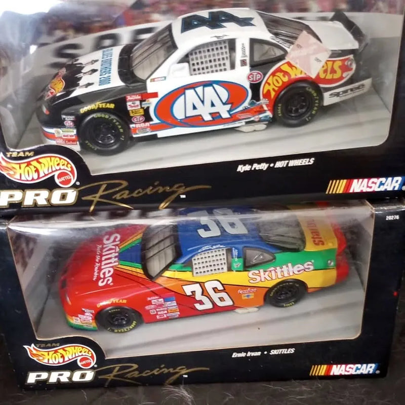 1:24 diecast racing cars in retail boxes, front view of two packaged models