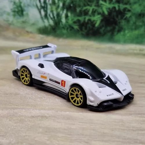 1/64 diecast model sports car, white with black hood and gold wheels, front view