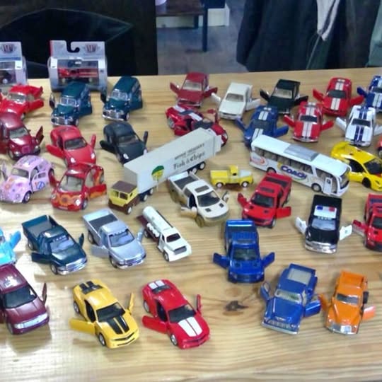 Assorted die-cast toy cars in red, blue, yellow, and white (many styles)
