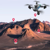 Mini quadcopter drone with front camera module and blue status lights, hovering overhead