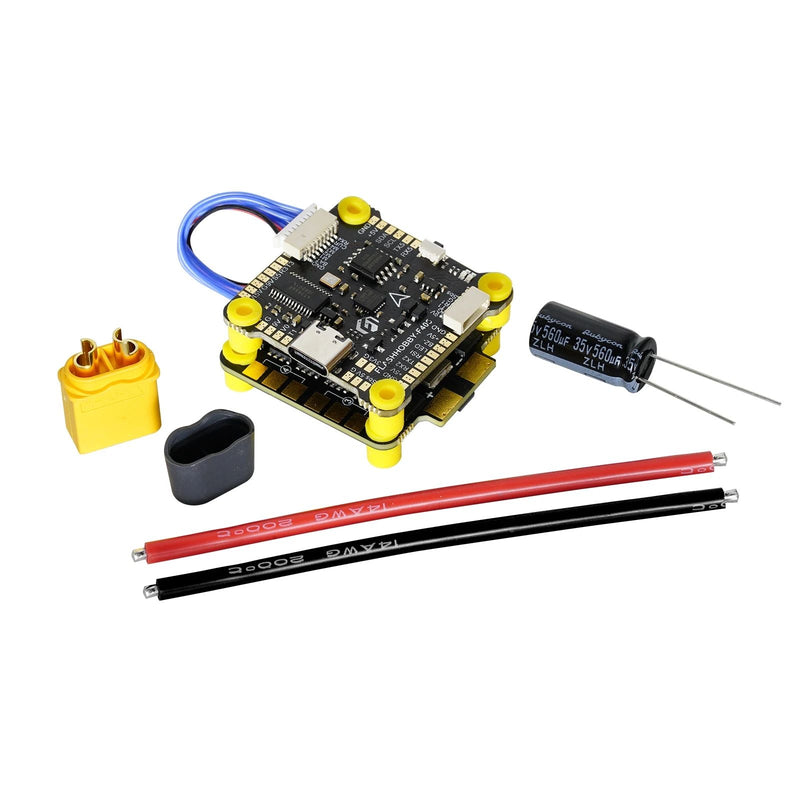 FPV flight controller board with blue wire, pins, and capacitors