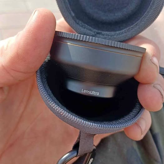 60mm telephoto lens with Lensuntra label in zippered fabric pouch