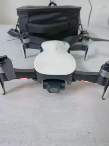 RC quadcopter drone with front gimbal and camera module, gray body