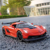 Diecast sports car model toy, red body with black wheels, front 3/4 view
