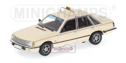 Cream and black taxi diecast model car with open grille and detailed wheels