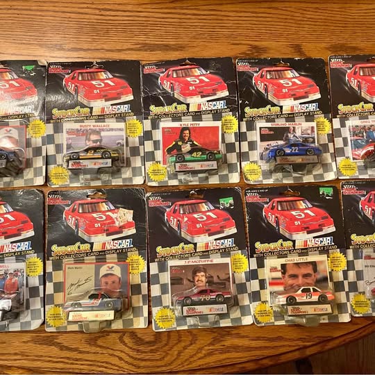 Diecast car collectible in blister packaging with collector card, red race car