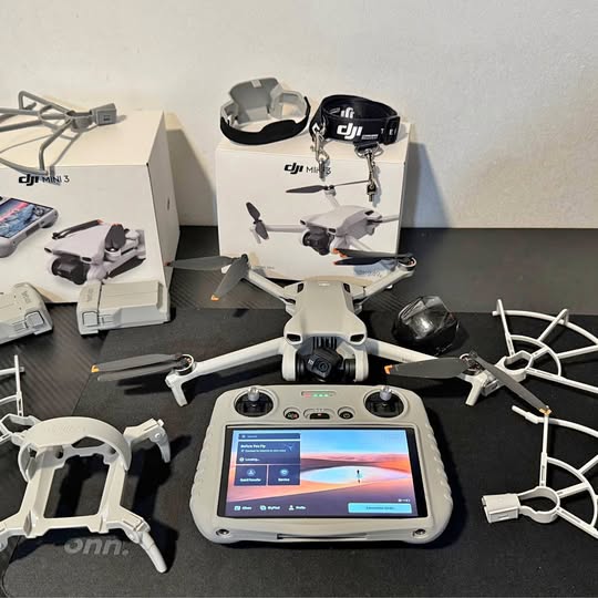 White quadcopter drone with handheld controller and tablet-style screen