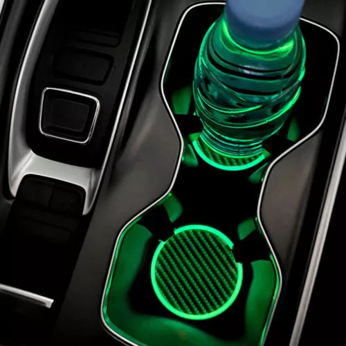 Green diecast toy car with detailed front, resting in a console tray