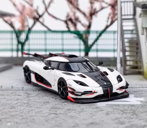 White 1:64 racing sports diecast resin car model with black hood and red accents