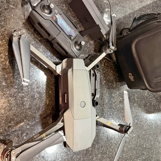 Gray foldable quadcopter drone with gimbal camera and controller