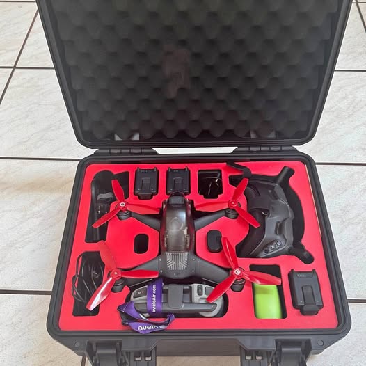 FPV racer drone in hard case with red foam insert and spare parts