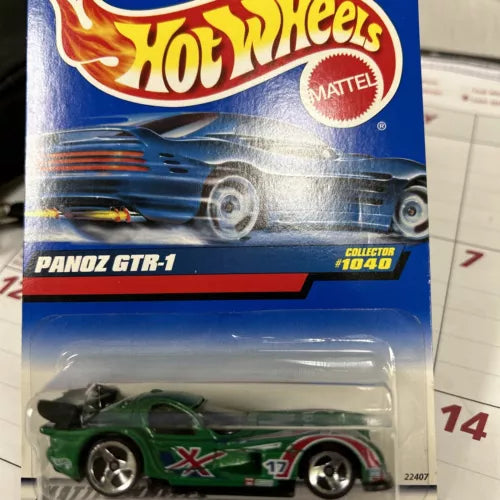 Hot Wheels diecast race car with green body, black wheels, in blister package