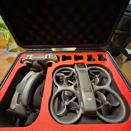 DJI drone with propellers in orange hard-shell carrying case