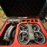 DJI drone with propellers in orange hard-shell carrying case