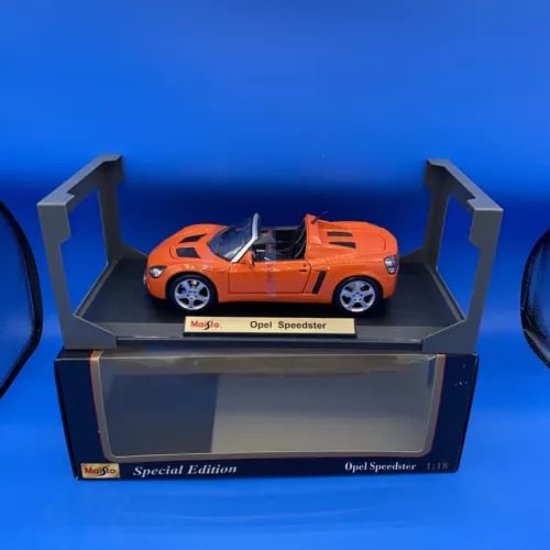 Orange convertible diecast sports car on display base in box
