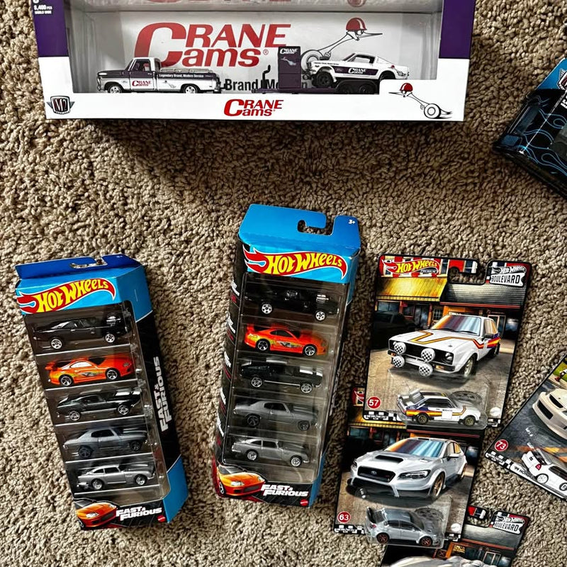 Diecast Hot Wheels car collection in retail boxes, assorted models and colors