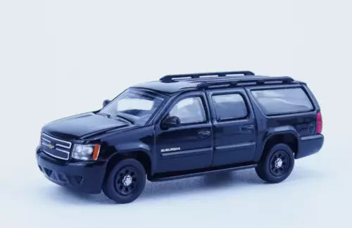 1:64 Chevrolet Suburban diecast SUV model, dark blue/black, side view