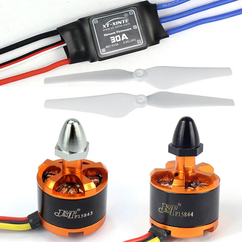 FPV quadcopter motor assembly with propellers, orange brushless motors and wiring