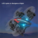 RC quadcopter drone with red body and blue LED navigation lights