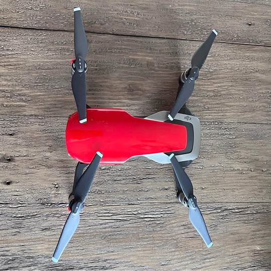 Red DJI Mavic Air drone with four folding propellers