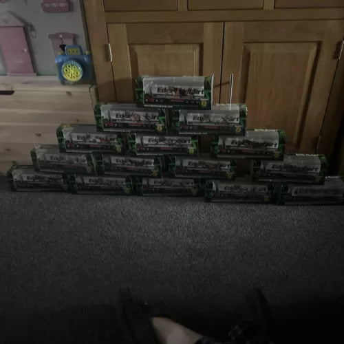 Stack of diecast truck model boxes with printed vehicle labels