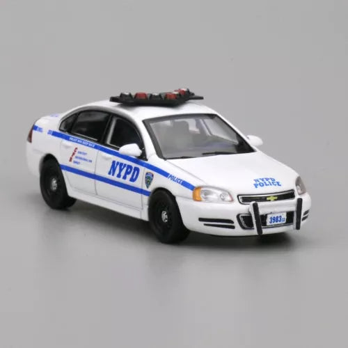 White NYPD police sedan diecast model car with side door text and front grille