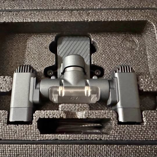 Metal drone search light mount with central lens and side bracket arms