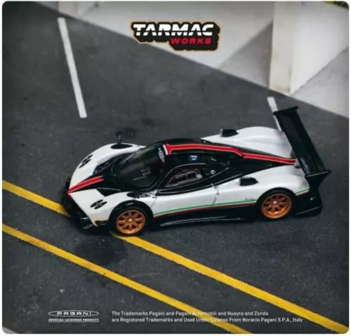 1:64 diecast race car model with white body, black accents, red stripes, rear wing