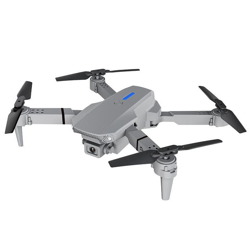 Gray quadcopter drone with four propellers and built-in camera