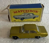 Gold and gray vintage diecast car model with opening doors, shown with packaging box