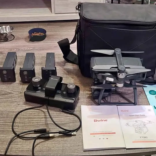 Bwine drone with controller and battery packs, plus carry bag and instruction manual