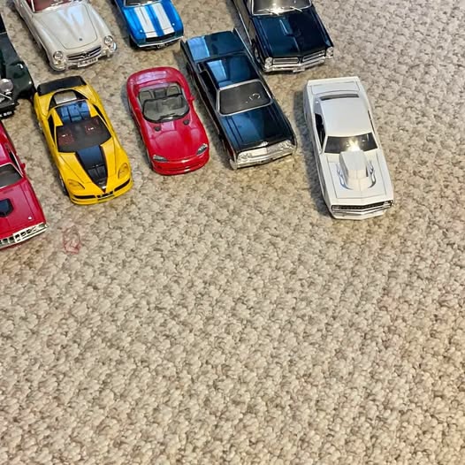 Assorted diecast collectible cars in yellow, red, blue, white, and silver