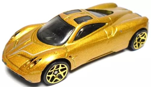 Gold diecast sports car toy with black roof and silver side stripes, front 3/4 view
