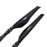 Black carbon fiber folding propeller blade pair with mounting holes and screws