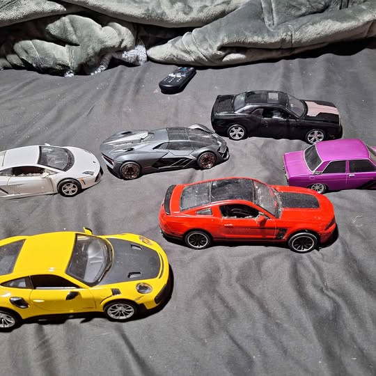 Diecast model cars set with yellow, white, silver, orange, purple, and black cars