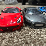 Diecast sports cars, red and gray, front view, detailed grilles and headlights