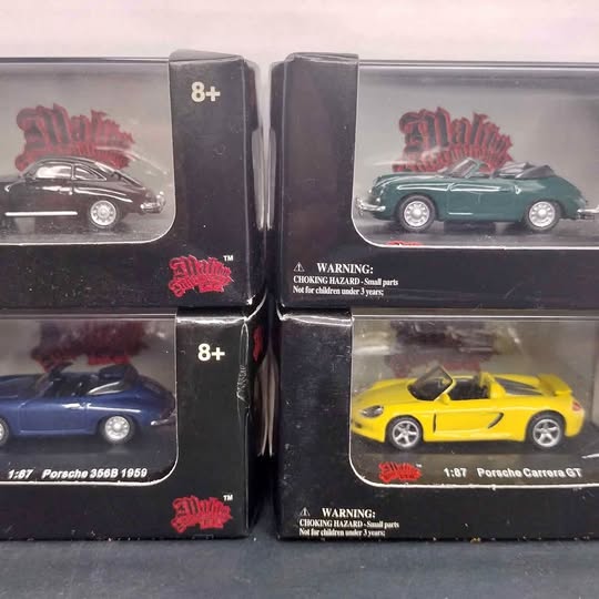 Set of four 1:87 diecast model cars in clear blister packaging, multicolor