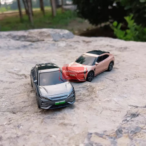 2-piece diecast model cars, silver and pink sports sedans, angled front view