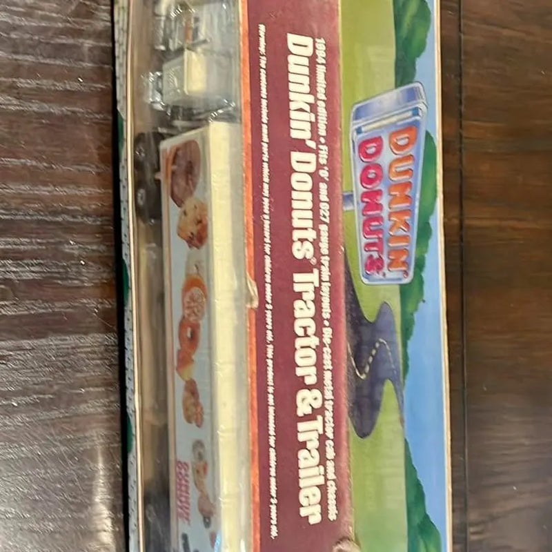 Diecast tractor-trailer toy in clear box with Dunkin’ themed graphics