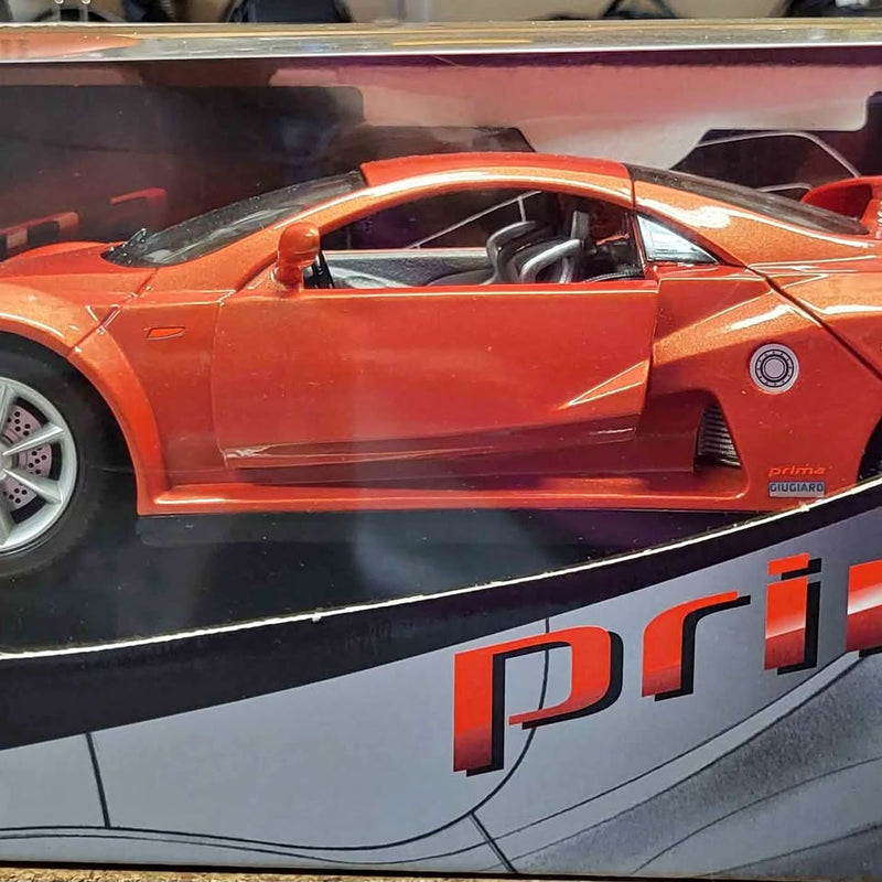 Orange 1/18 diecast sports car with open cockpit and white wheel rims