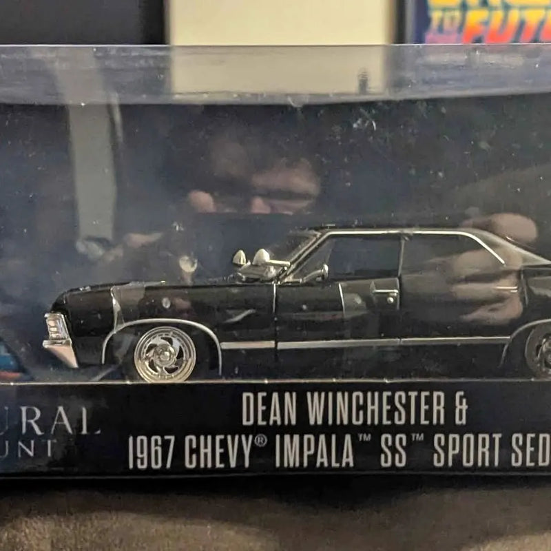 Black diecast 1967 Chevy Impala SS Sport Sedan with Dean Winchester on base