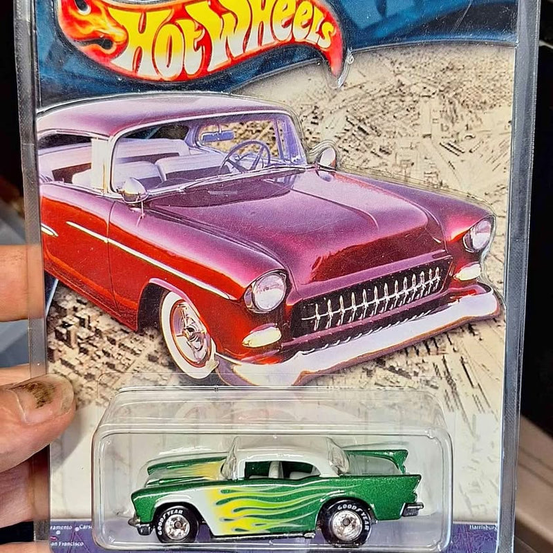 Green diecast toy car with yellow flame graphics, in clear blister packaging