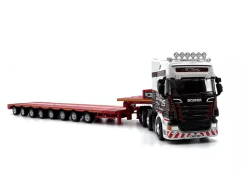 Diecast low-load multi-axle trailer truck model with red flatbed and SCANIA cab