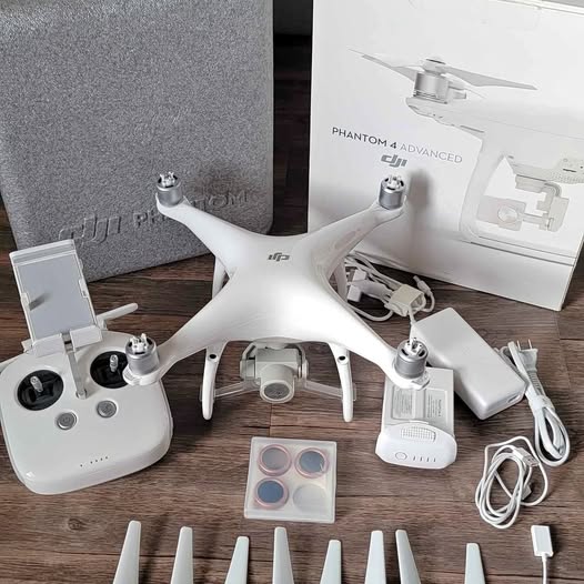 DJI Phantom 4 Advanced drone with white body and foldable propellers, controller and accessories