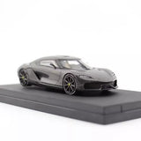 1:64 scale black metal diecast sports car, front three-quarter view with base