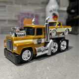 Yellow and chrome diecast semi truck with open exhaust stacks