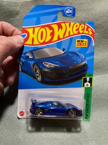 Hot Wheels diecast car in blue blister pack with RIMAC NEVERA graphic