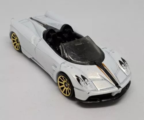 White pearlescent roadster diecast car with black hood and gold wheels, front 3/4 view